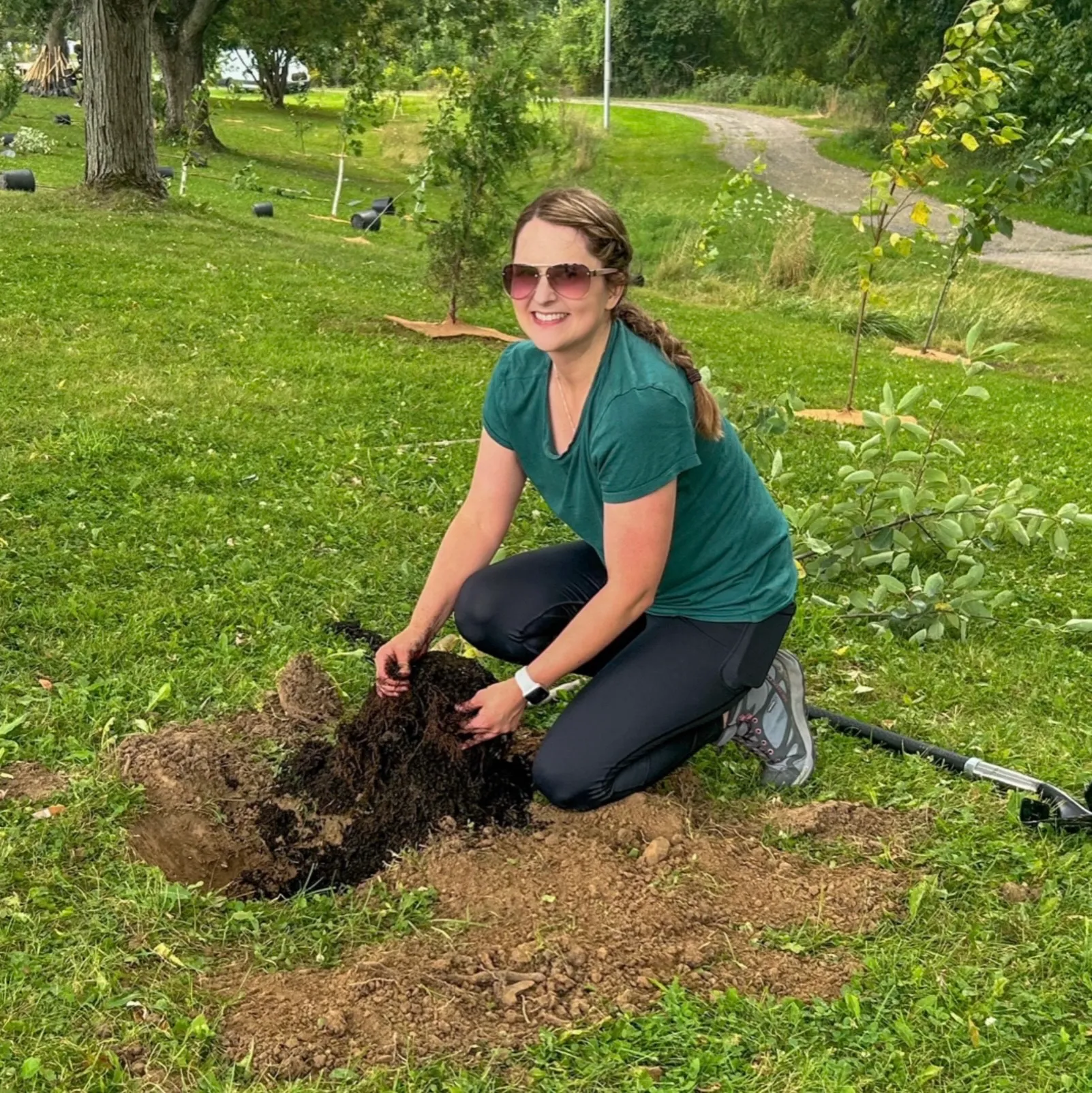 Volunteer plants a tree at McMaster campus