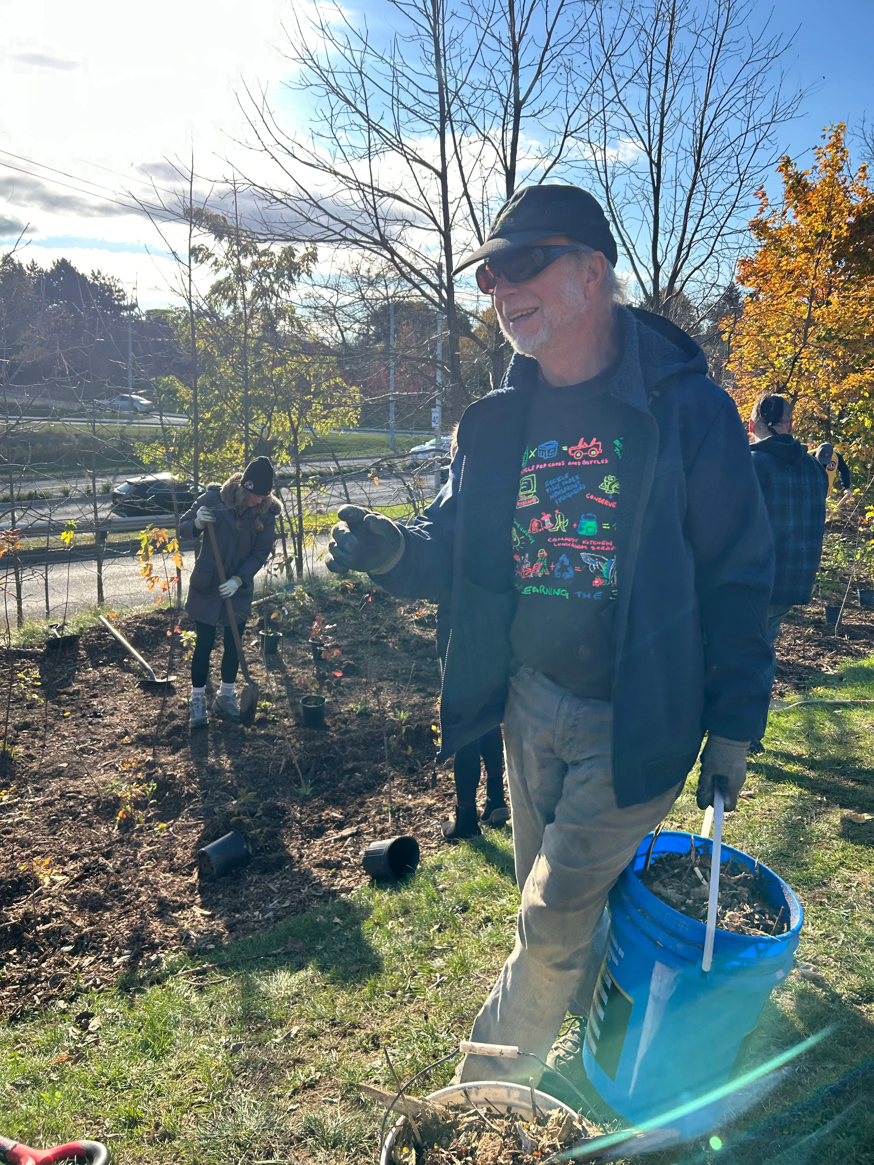 Volunteers plant trees at a city parkette